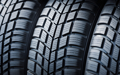 Close-up detailed view of a new tire tread pattern showing deep grooves and sipes for enhanced grip and traction on various surfaces