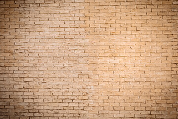 Fototapeta premium Abstract Background of beige brick wall with smooth masonry with warm shade and brick texture. Natural light shows durability, classic. Beautiful architecture, interior, exterior