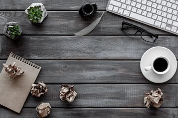 Vintage style writer working place with lumps paper drafts, top view