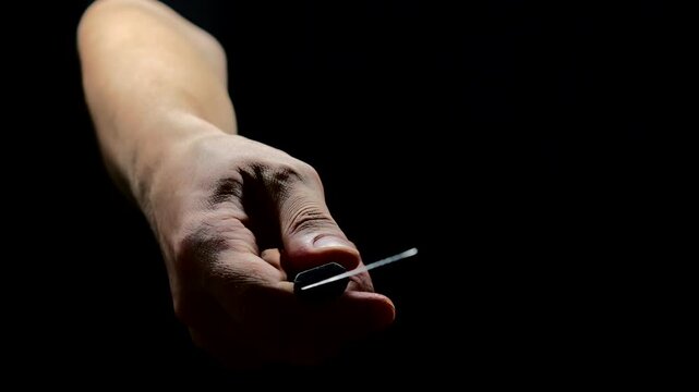 a dangerous criminal prepares to commit an attack and rob someone at night with a knife in his hands.
The concept of crime and showdowns.
Robbery with a knife