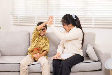 Therapy, child, counseling, psychologist, counselor joyful play with young boy smiling with bear on...