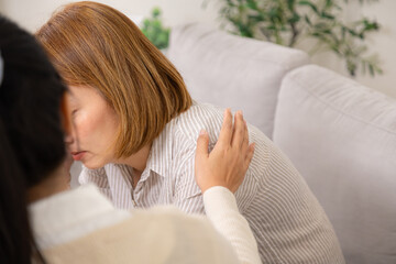 Therapy, depression, counseling, woman, captured as female therapist gently comforts depressed...