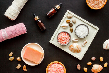 Essential oil in bottles and spa cosmetics with towels, top view. Beauty spa therapy cosmetics and wellness flat lay