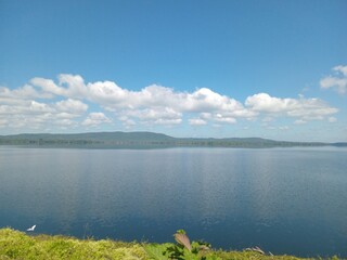 Expansive Blue Lake Landscape with Distant Hills