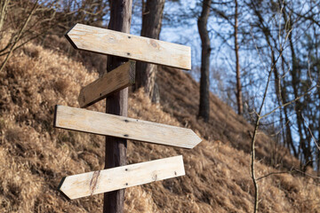 wooden rustic road sign in outskirts environment blurred background