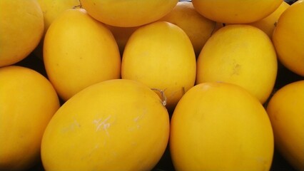 Fresh Vibrant Yellow Melons Piled Ripe Produce Display. perfect for food and grocery marketing.