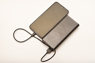 Charging a mobile phone from a powerbank. Charging the gadget.