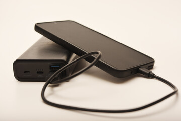 Charging a mobile phone from a powerbank. Charging the gadget.