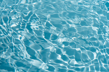 Blue water with ripples on the surface. Defocus blurred transparent blue colored clear calm water...