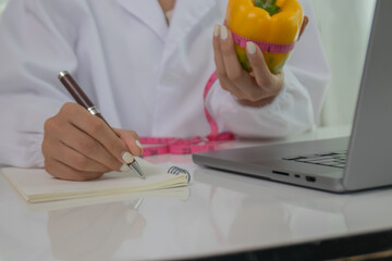 A female lab technician examines broccoli for scientific research in microbiology, biotechnology, and nutrition to advance health.