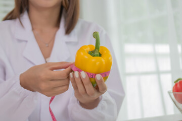 A female lab technician examines broccoli for scientific research in microbiology, biotechnology, and nutrition to advance health.