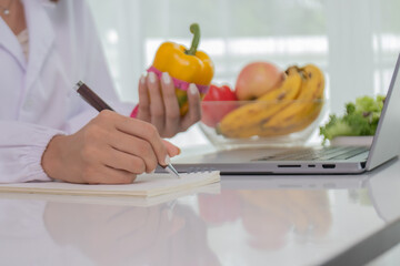 A female lab technician examines broccoli for scientific research in microbiology, biotechnology, and nutrition to advance health.