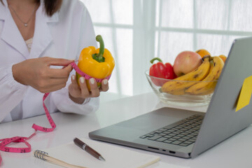 A female lab technician examines broccoli for scientific research in microbiology, biotechnology, and nutrition to advance health.