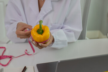 A female lab technician examines broccoli for scientific research in microbiology, biotechnology, and nutrition to advance health.