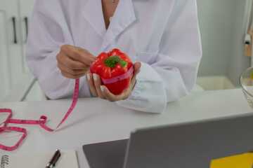 A female lab technician examines broccoli for scientific research in microbiology, biotechnology, and nutrition to advance health.