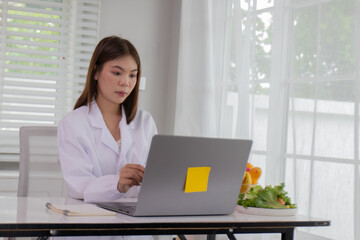A female lab technician examines broccoli for scientific research in microbiology, biotechnology, and nutrition to advance health.