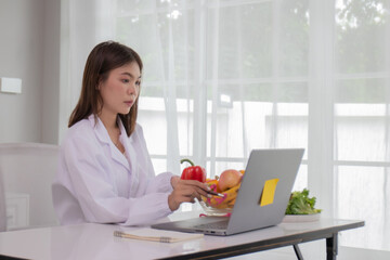 A female lab technician examines broccoli for scientific research in microbiology, biotechnology, and nutrition to advance health.