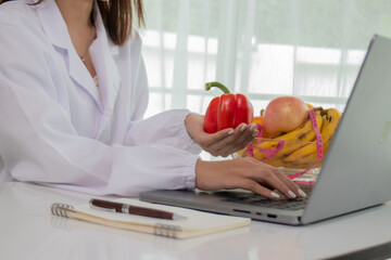 A female lab technician examines broccoli for scientific research in microbiology, biotechnology, and nutrition to advance health.