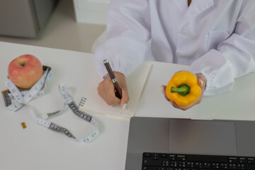 A female lab technician examines broccoli for scientific research in microbiology, biotechnology, and nutrition to advance health.