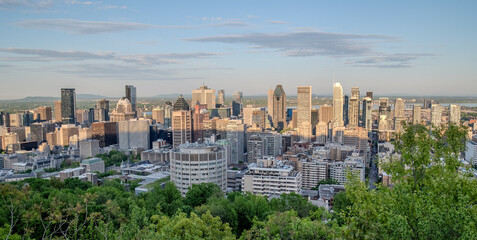 Fototapeta premium Montreal city skyline panorama at sunset viewed from Mont Royal with urban skyscrapers.