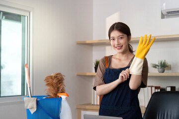 Home Cleaning. Person preparing to clean with gloves and tools.