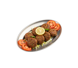 Chapli kabab with lemon and tomato isolated on white background.