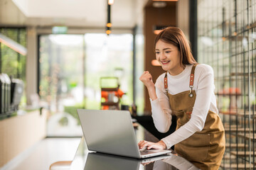 Young entrepreneur feeling happy about her online business growth