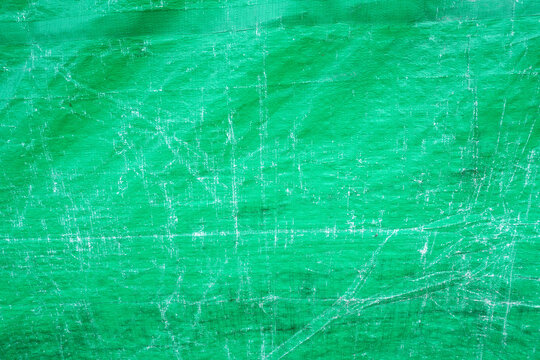 Vibrant green tarp with distressed texture for creative projects