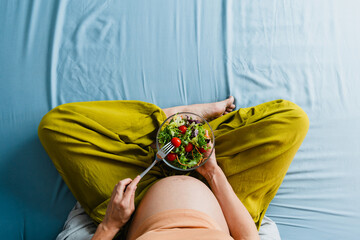 Pregnant woman eating healthy salad, prenatal nutrition and lifestyle during pregnancy