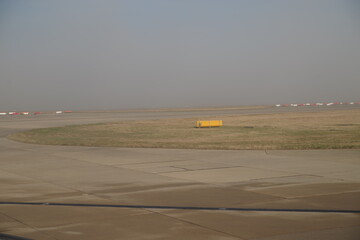 Yellow sign sits in the middle of a dry, dusty field