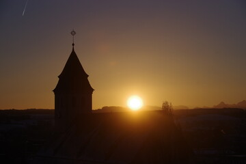 Tall building with a pointed roof and a weather vane on top