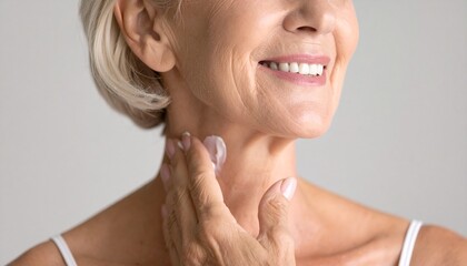 Smiling Old Woman Applying Cream on Neck