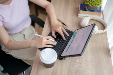 Businesswoman working with tablet and keyboard at home office desk