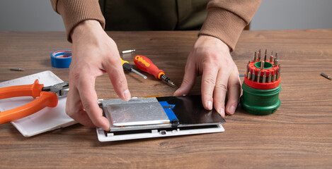 Caucasian man repairing broken tablet. Tablet repair