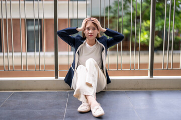 Young woman sitting on balcony in contemplation