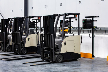 Electric forklifts charging inside warehouse