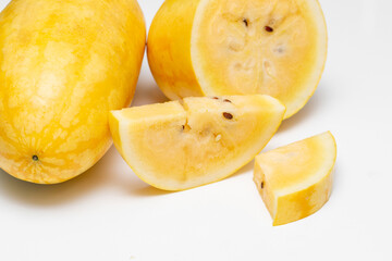 Yellow Watermelon Cut into Pieces on White Background