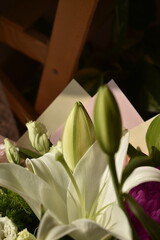 close-up white lily with bud in big bouquet