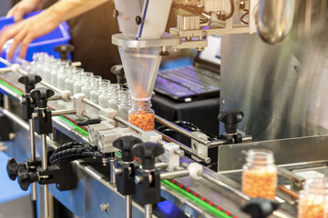 Tablet / Capsule counting machine conveyor in production line of pharmaceutical industry.