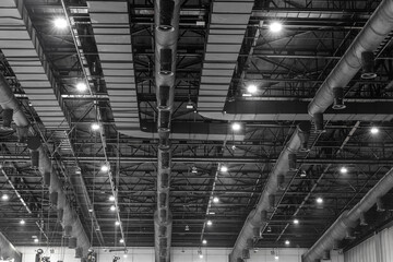 HVAC Duct Cleaning, Ventilation pipes in silver insulation material hanging from the ceiling inside...