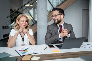 Business people having fun while working on project in office