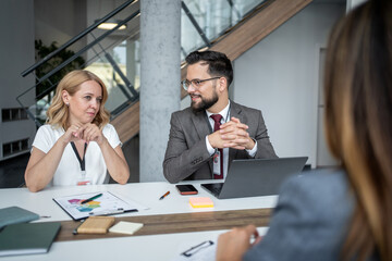 Business people having meeting in modern office discussing charts and reports