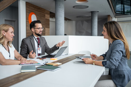 Recruiters interviewing applicant for job position in modern office