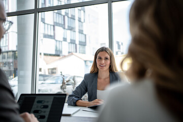 Businesswoman leading a meeting with colleagues in modern office