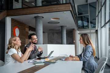 Managers interviewing candidate for job position in modern office