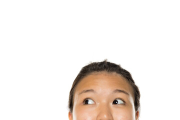 Upper half of Asian woman's face looking up with blank white background, studio shot with copy space.
