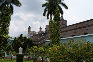 Fototapeta premium arranged garden inside the church courtyard with some of building structures at bandel church