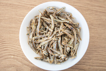 A bowl of dried anchovy fish. Side dish. Fish dish, seafood