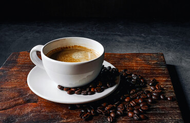 Coffee cup and coffee beans on gray background,  Espresso coffee cup aromatic on a wooden tray