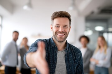 Fototapeta premium Man offering handshake in an office friendly and professional